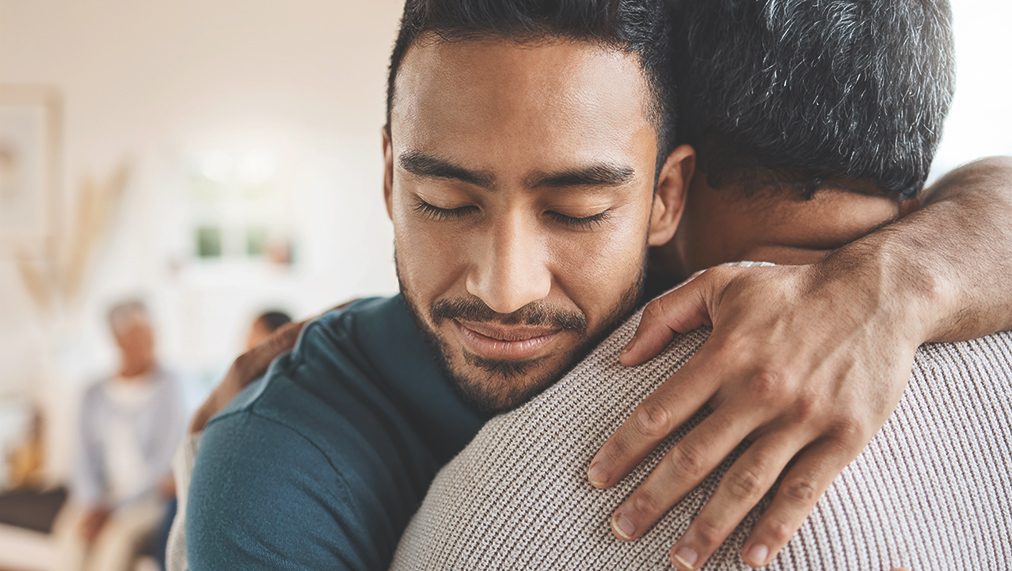 Two persons hugging